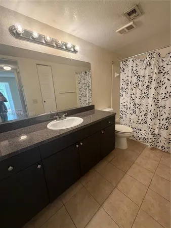 a bathroom with a sink a mirror and a shower