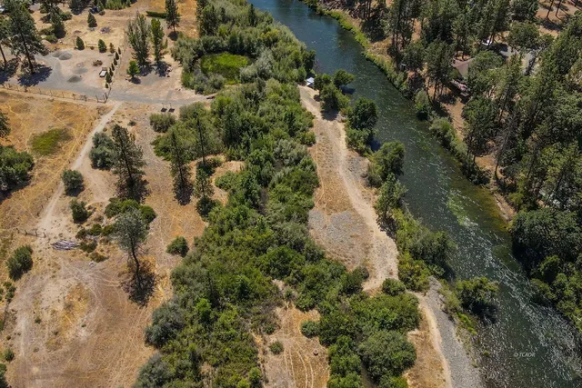 an aerial view of a houses with a yard