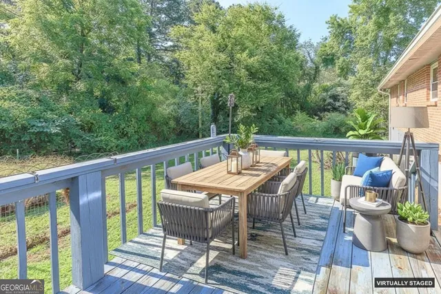 a view of balcony with furniture and trees