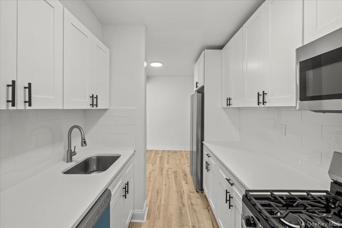 3635 Johnson Avenue, Unit 4M Bronx, NY 10463 - Photo 12 of 21 a kitchen with a sink and a stove top oven