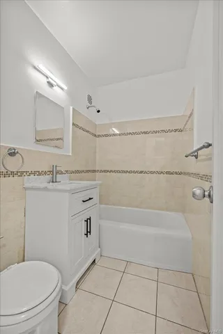 a bathroom with a granite countertop toilet a sink and bathtub