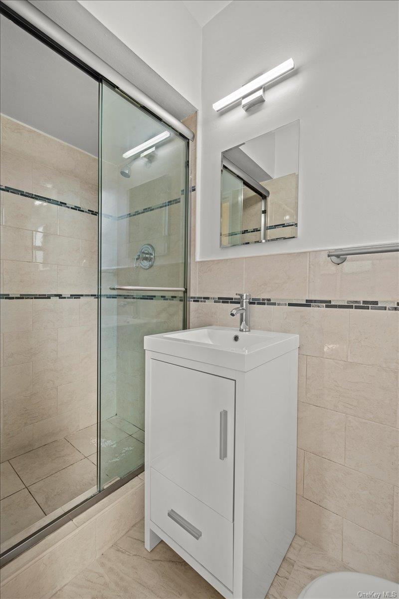 3635 Johnson Avenue, Unit 4M Bronx, NY 10463 - Photo 20 of 21 a bathroom with a sink and mirror