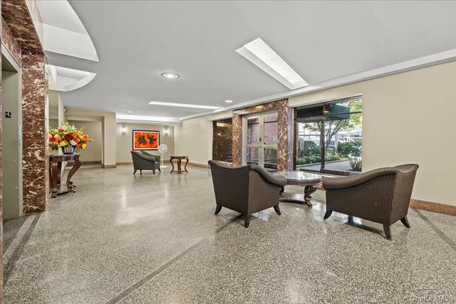 a living room with furniture and a potted plant