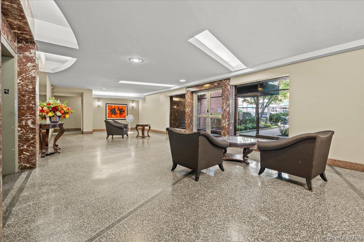 3635 Johnson Avenue, Unit 4M Bronx, NY 10463 - Photo 4 of 21 a living room with furniture and a potted plant