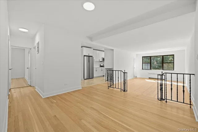 a view of a livingroom with wooden floor and furniture
