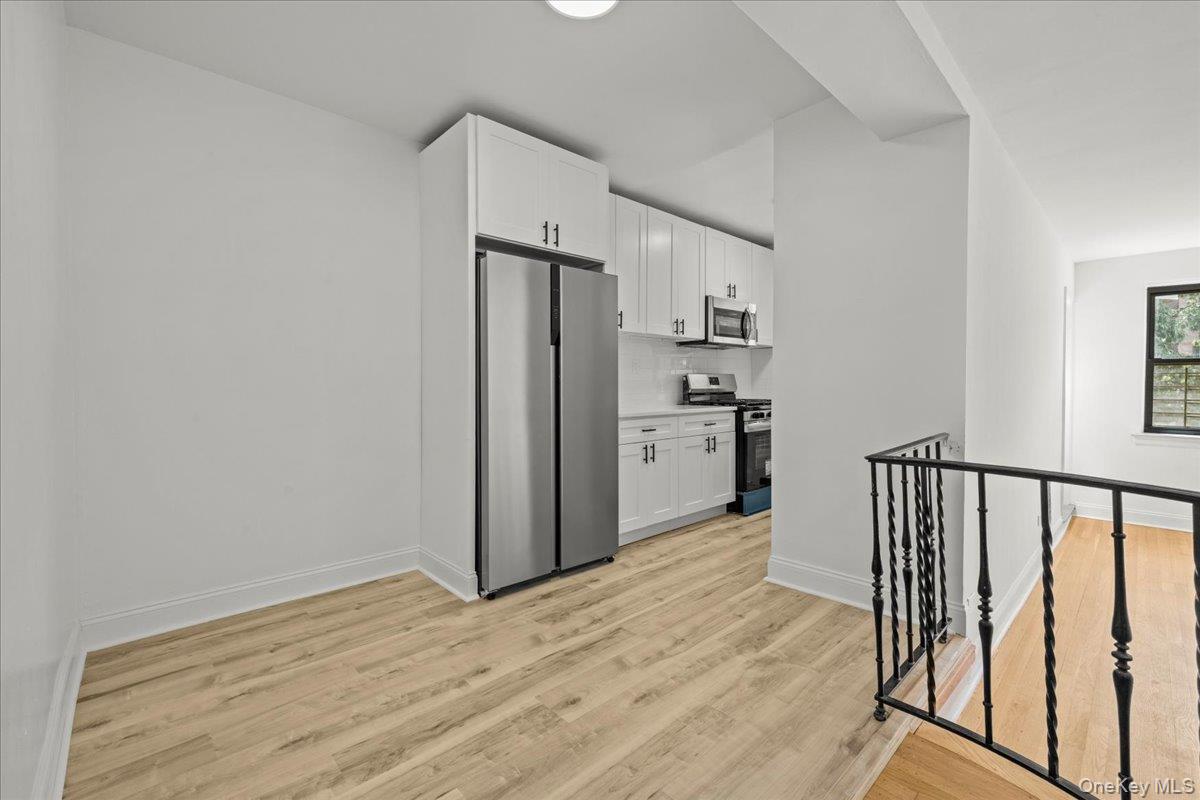 3635 Johnson Avenue, Unit 4M Bronx, NY 10463 - Photo 10 of 21 a view of a kitchen with a sink refrigerator and wooden floor