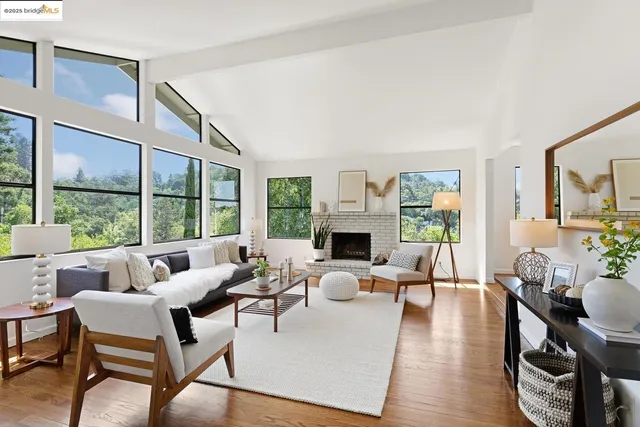 a living room with furniture a fireplace and a table