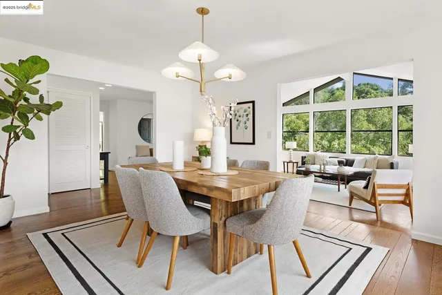 a view of living room kitchen with stainless steel appliances granite countertop furniture and fireplace