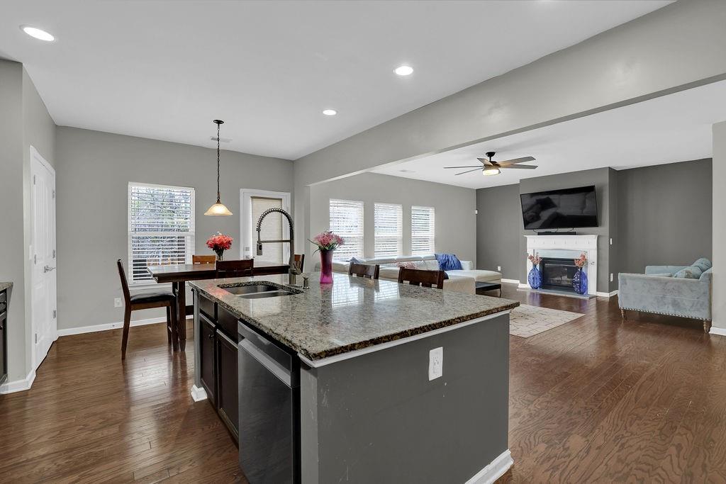 333 Nobleman Way Canton, GA 30114 - Photo 15 of 31 a kitchen with stainless steel appliances granite countertop a sink a stove and a wooden floors