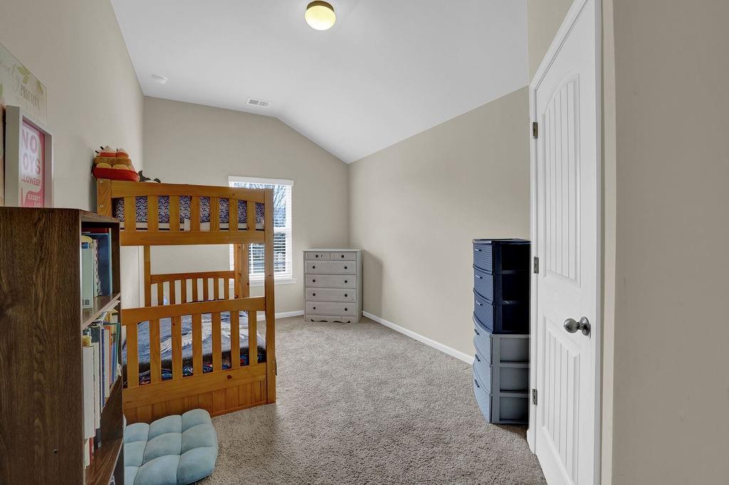 333 Nobleman Way Canton, GA 30114 - Photo 18 of 31 a bedroom with furniture and a window