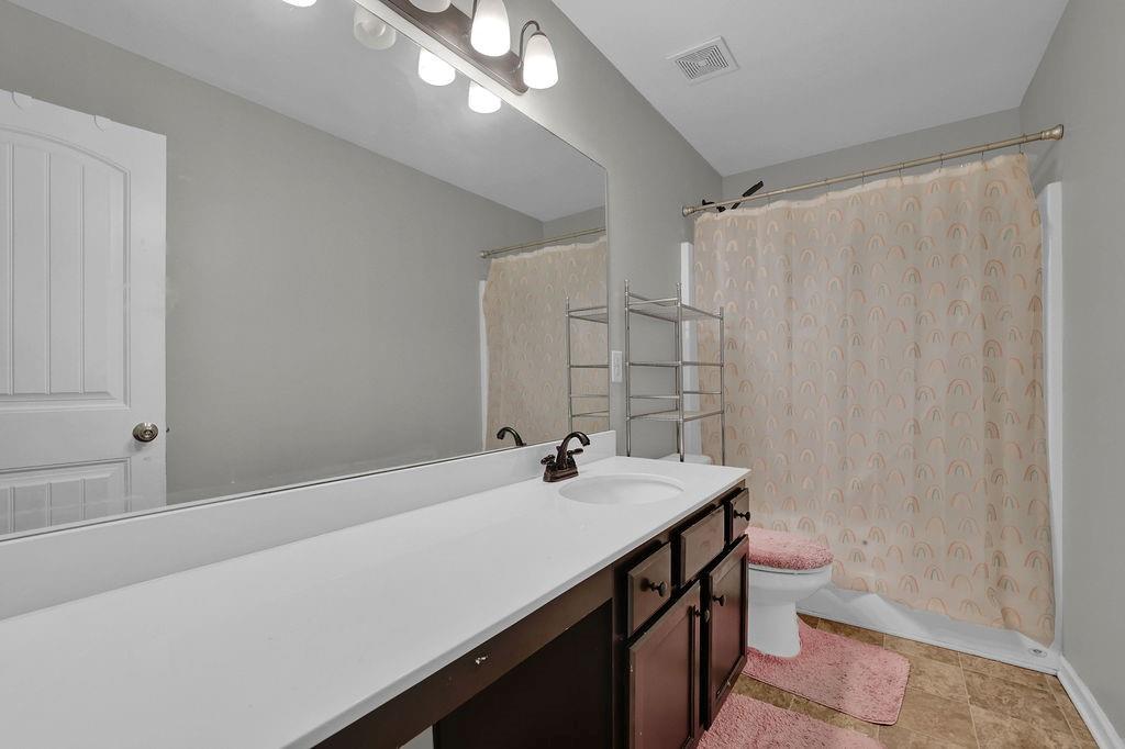 333 Nobleman Way Canton, GA 30114 - Photo 20 of 31 a bathroom with a sink a toilet and shower
