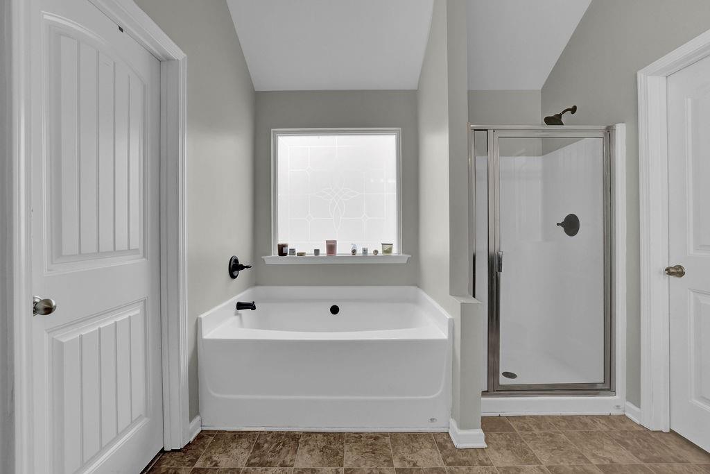 333 Nobleman Way Canton, GA 30114 - Photo 26 of 31 a bathroom with a tub and a shower