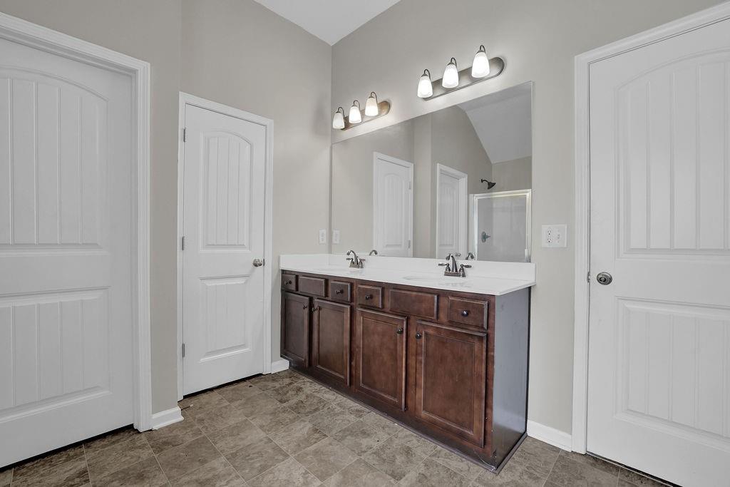 333 Nobleman Way Canton, GA 30114 - Photo 27 of 31 a bathroom with a double vanity sink and a mirror