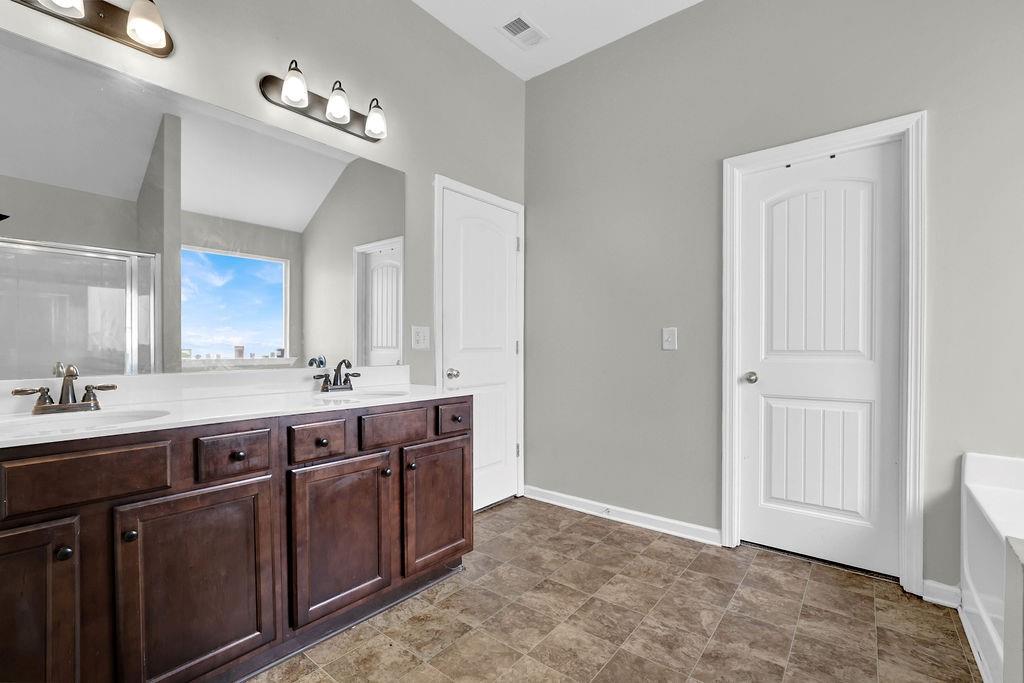 333 Nobleman Way Canton, GA 30114 - Photo 28 of 31 a spacious bathroom with a double vanity sink and a mirror
