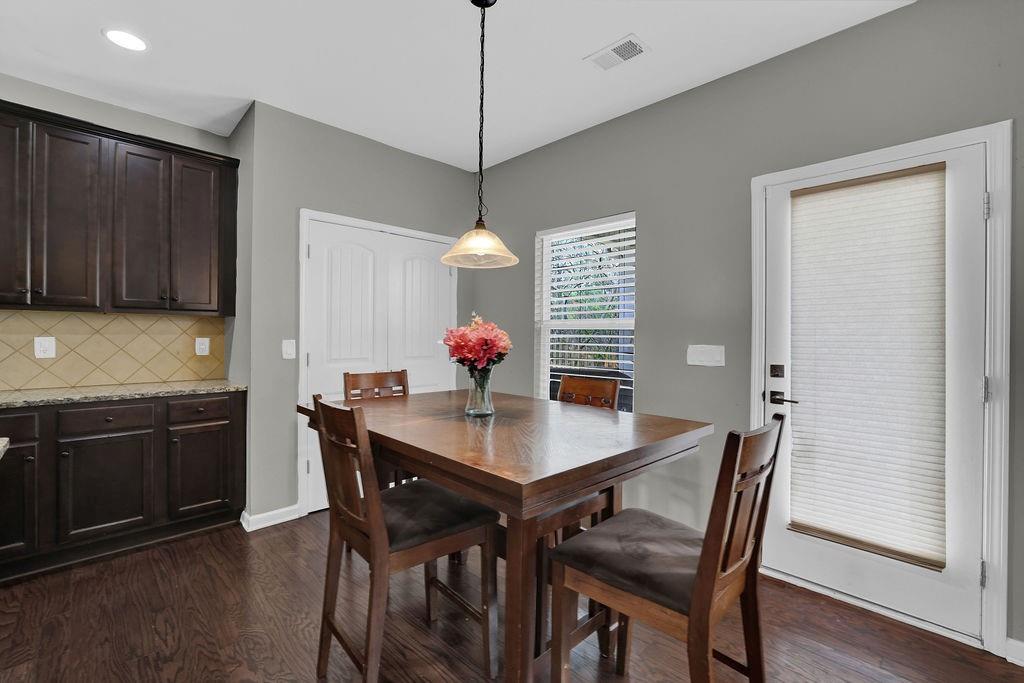 333 Nobleman Way Canton, GA 30114 - Photo 10 of 31 a view of a dining room with furniture and wooden floor