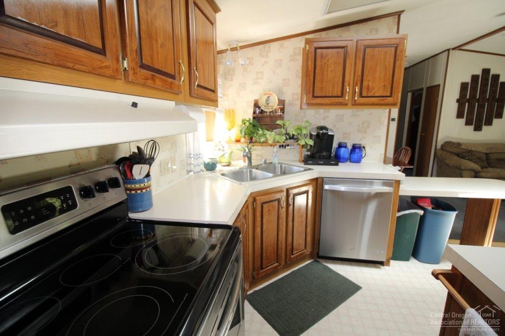 19235 Kiowa Road Bend, OR 97702 - Photo 9 of 25 a kitchen with a sink stove and cabinets