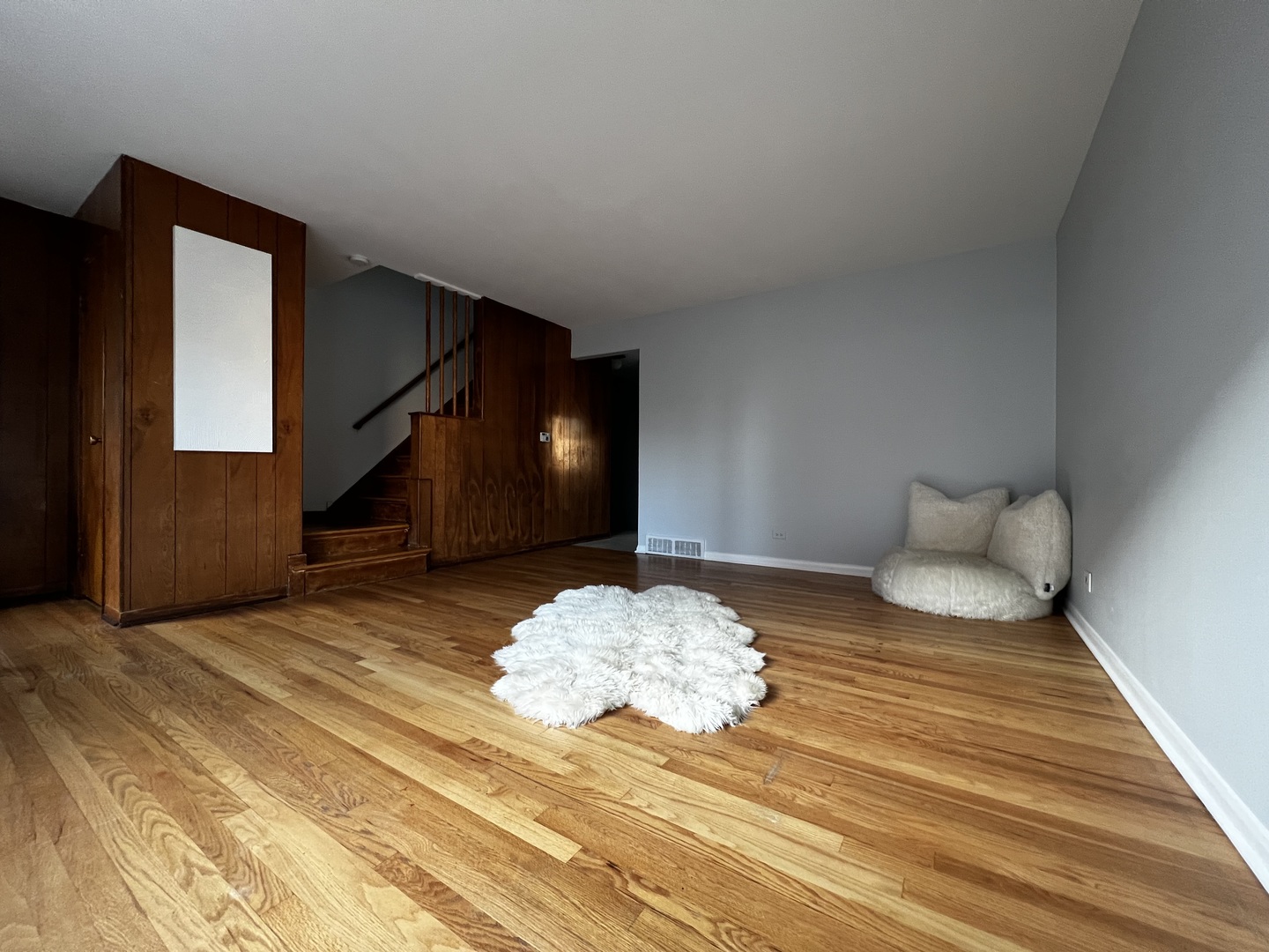 8653 Niles Center Road, Unit D Skokie, IL 60077 - Photo 4 of 8 a bedroom with a bed and a mirror