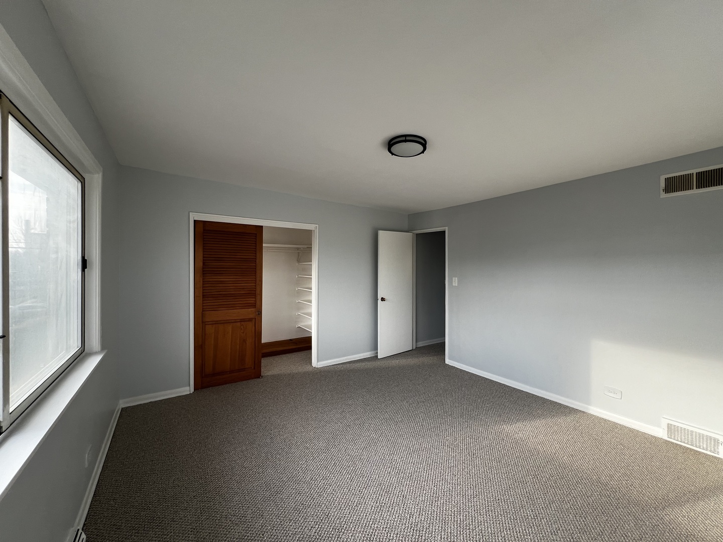 8653 Niles Center Road, Unit D Skokie, IL 60077 - Photo 6 of 8 an empty room with windows