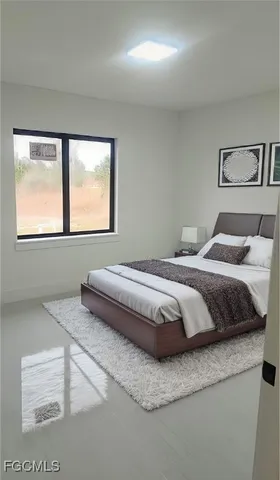 a bedroom with a bed and two lamps