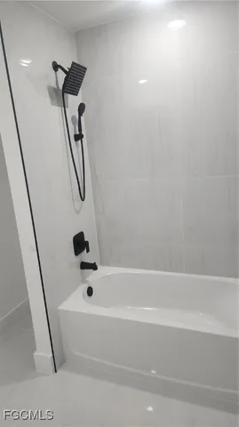 a bathroom with a bathtub and shower
