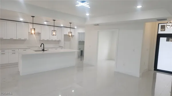 a bathroom with a sink a shower and a mirror