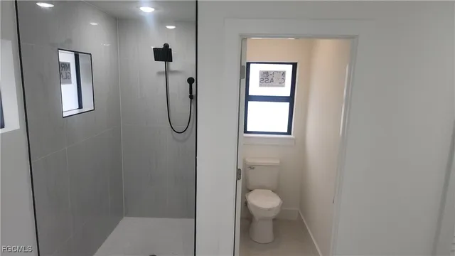 a bathroom with a toilet sink and shower