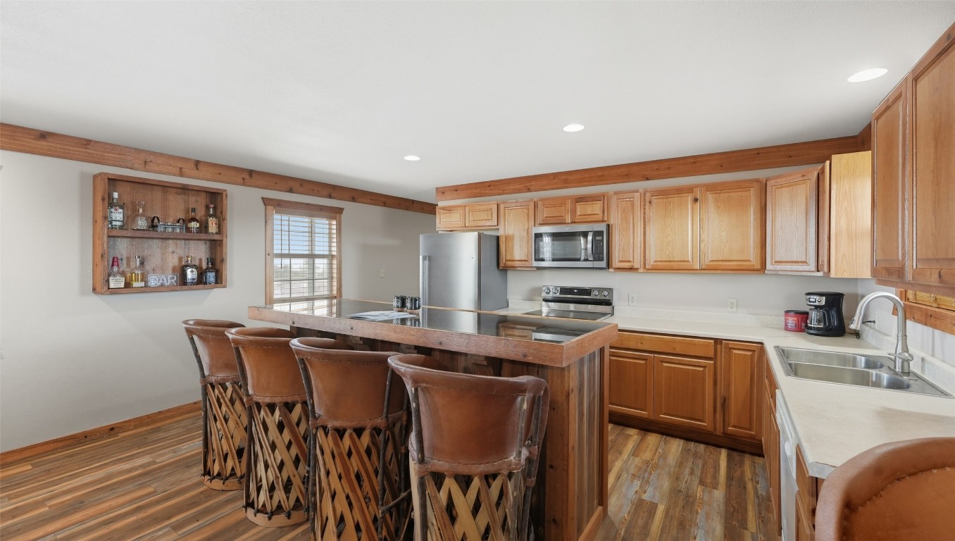 0 Ranch To Market 3008 Ranch Brackettville, TX 78832 - Photo 16 of 40 a kitchen with stainless steel appliances granite countertop a table chairs sink and cabinets