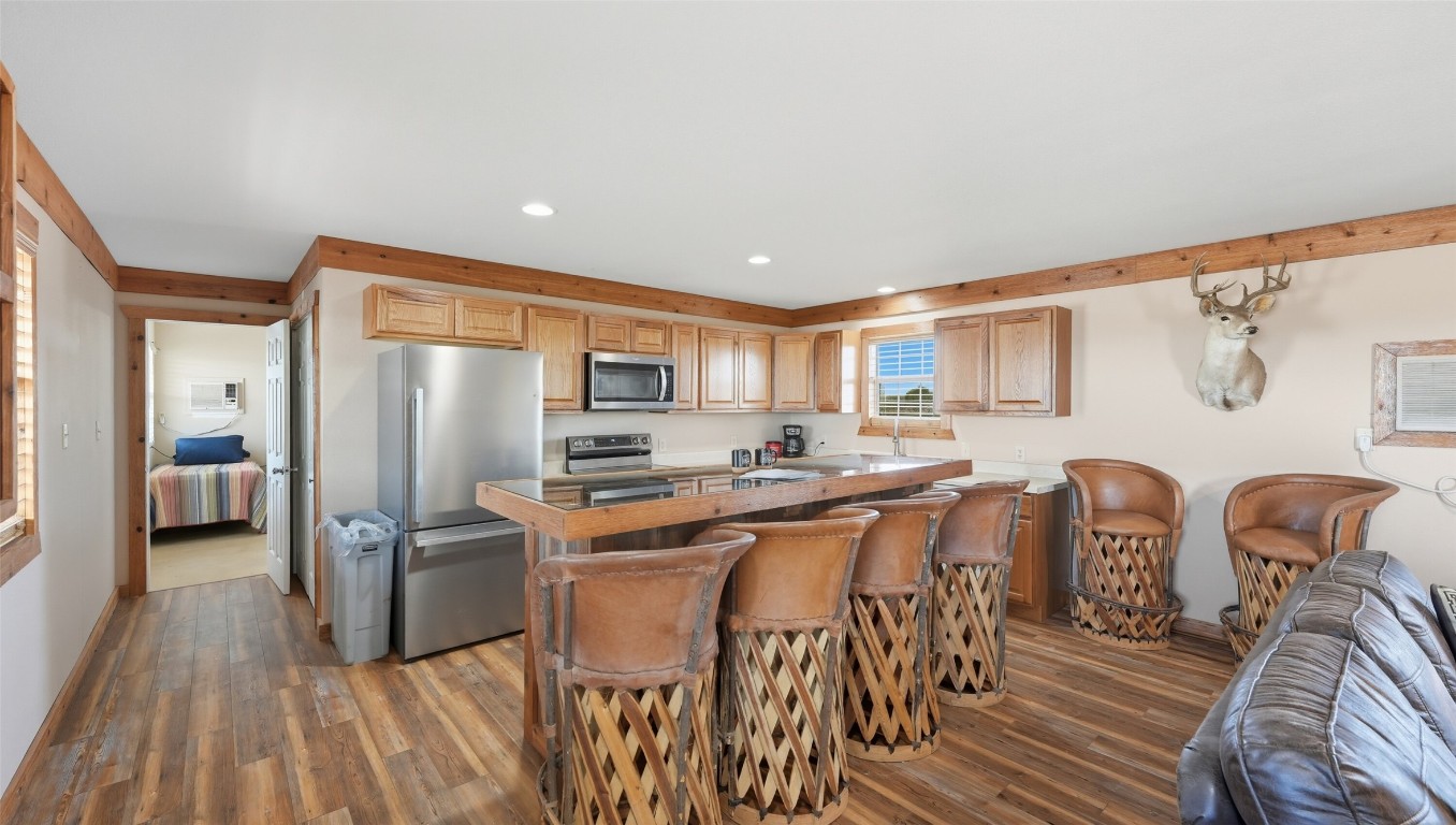 0 Ranch To Market 3008 Ranch Brackettville, TX 78832 - Photo 17 of 40 a kitchen with stainless steel appliances a dining table chairs and a refrigerator