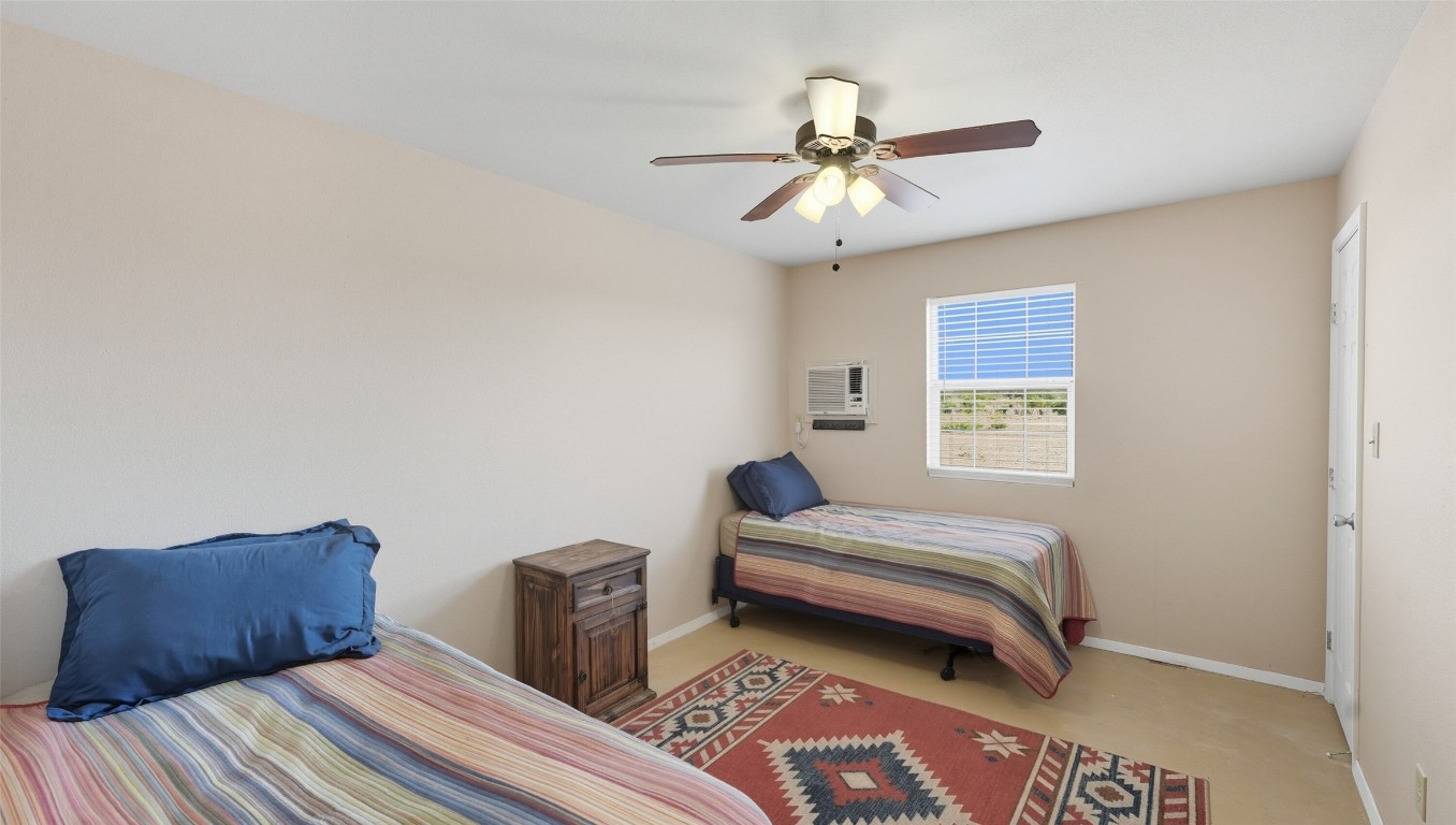 0 Ranch To Market 3008 Ranch Brackettville, TX 78832 - Photo 22 of 40 a bedroom with a bed and a chandelier