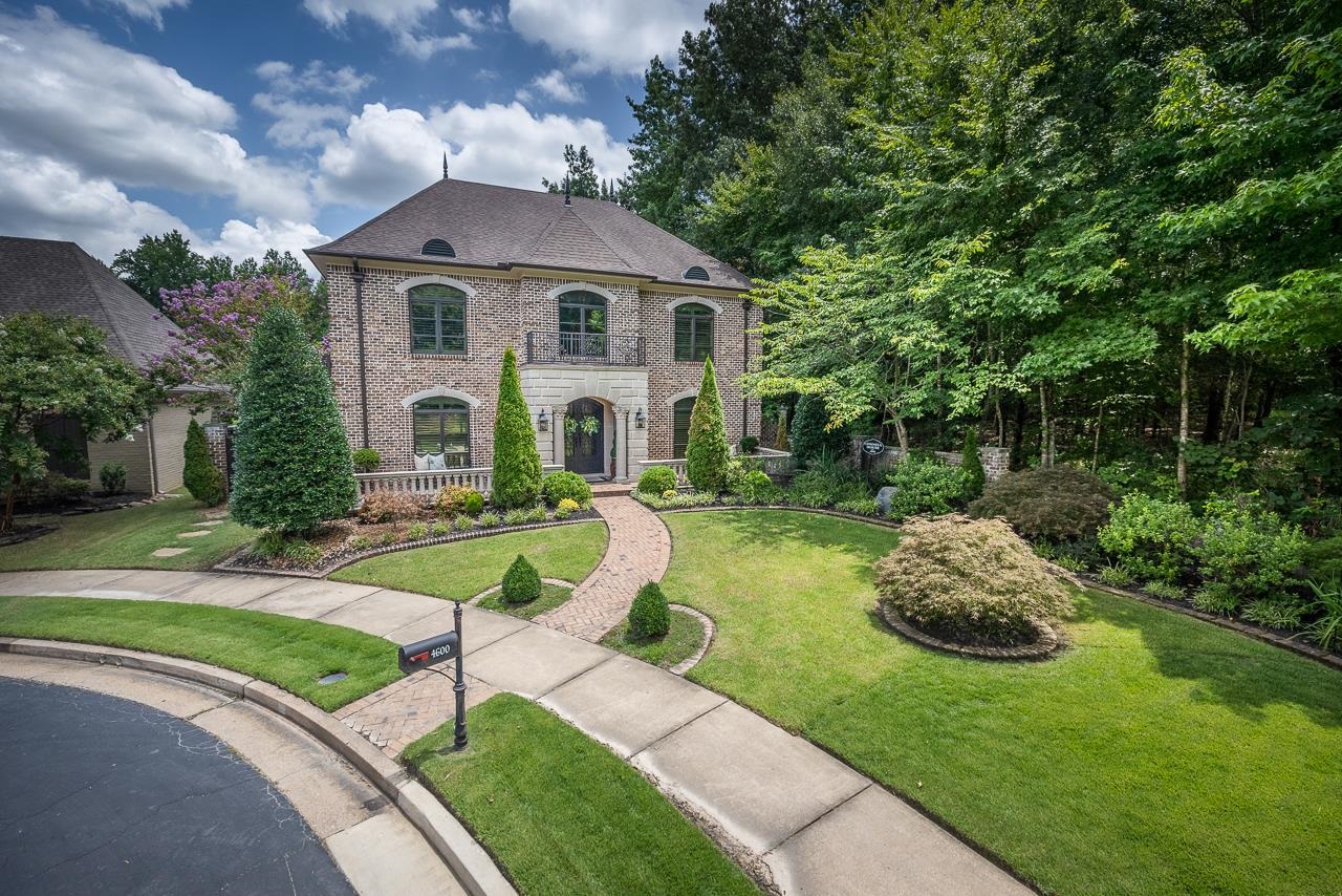 a front view of a house with a yard table and chairs