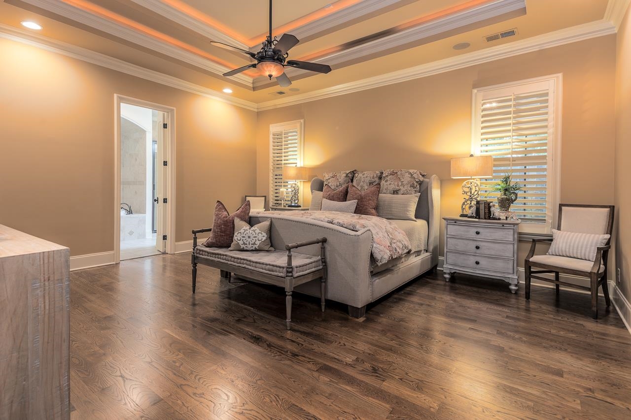 4600 Maple Glen Court Lakeland, TN 38002 - Photo 20 of 40 a spacious bedroom with a bed and a chandelier