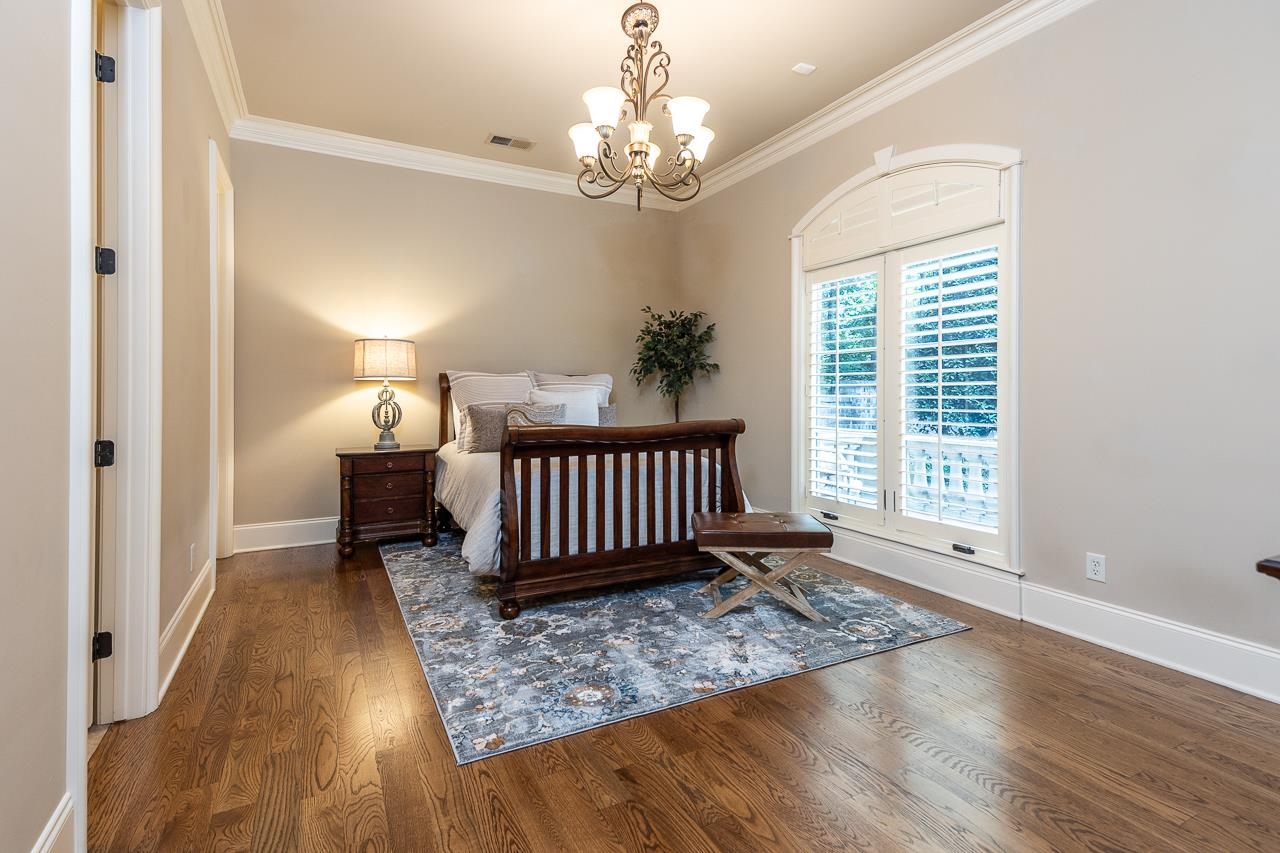 4600 Maple Glen Court Lakeland, TN 38002 - Photo 23 of 40 an empty room with wooden floor windows and a chandelier
