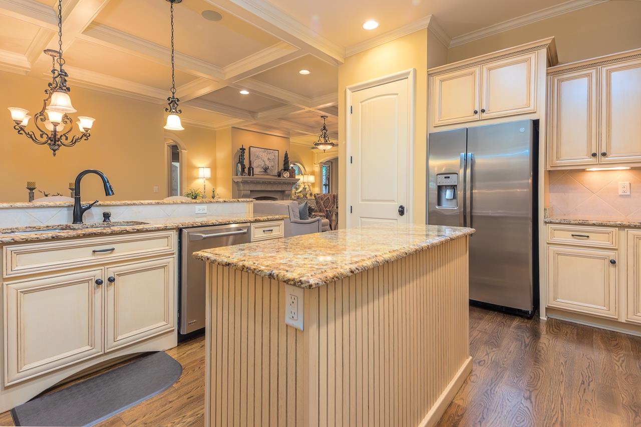 4600 Maple Glen Court Lakeland, TN 38002 - Photo 6 of 40 a kitchen with stainless steel appliances granite countertop a sink and dishwasher refrigerator a microwave oven with wooden floor