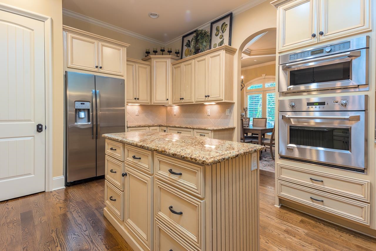 4600 Maple Glen Court Lakeland, TN 38002 - Photo 9 of 40 a kitchen with granite countertop a stove oven and refrigerator