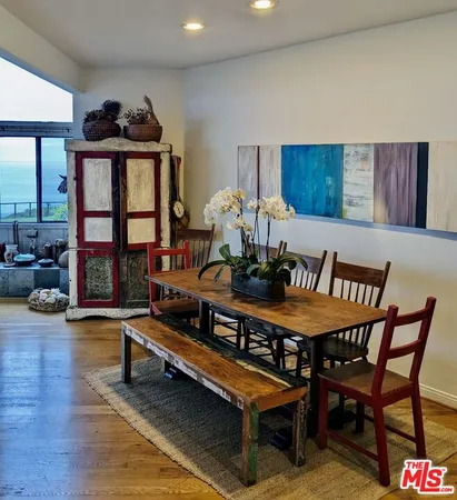 a living room with furniture a rug and a floor to ceiling window