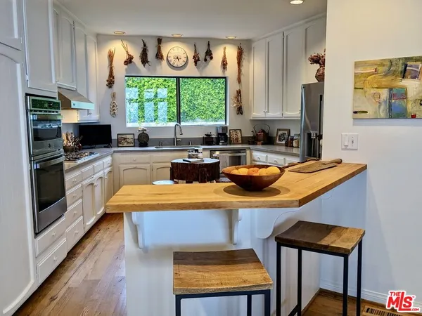 a kitchen with a stove a sink and a refrigerator