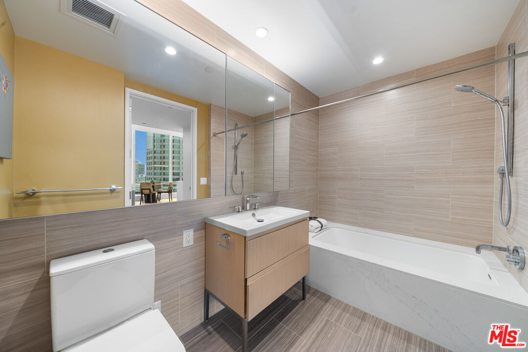 877 Francisco Street, Unit 1906 Los Angeles, CA 90017 - Photo 15 of 31 a bathroom with a sink double vanity mirror and a bathtub