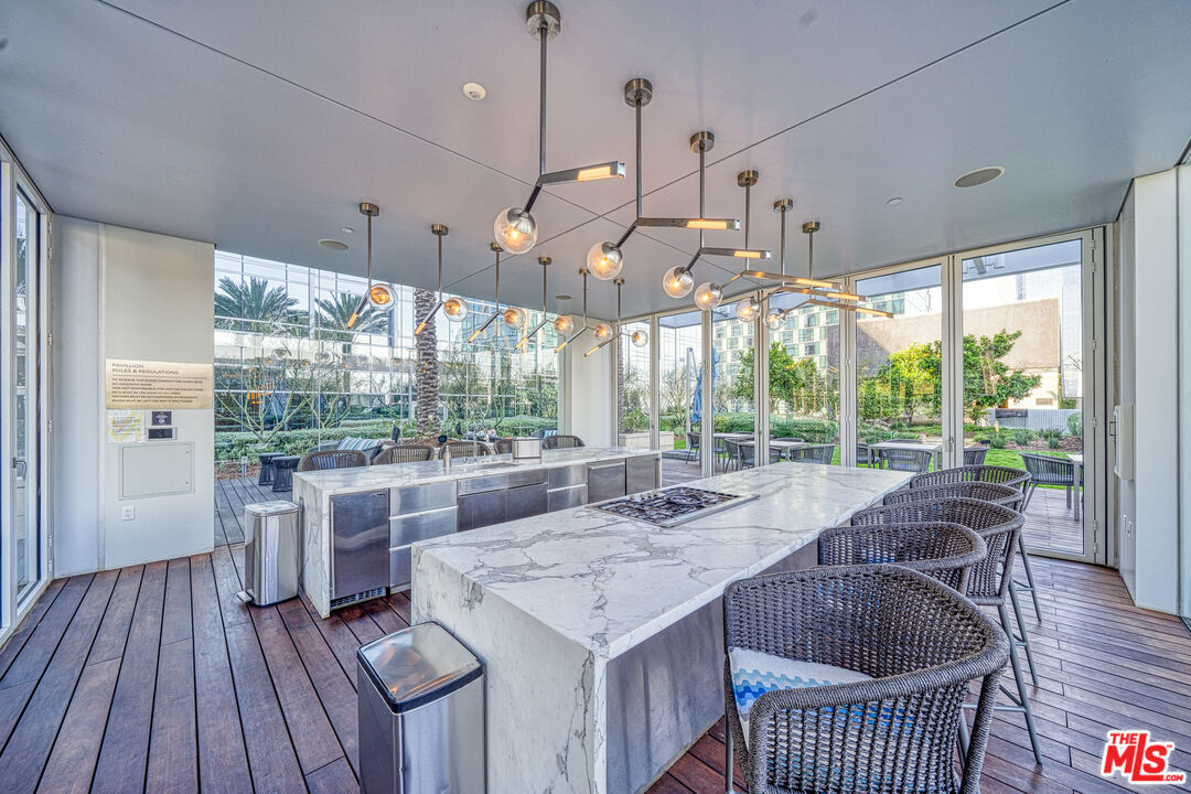 877 Francisco Street, Unit 1906 Los Angeles, CA 90017 - Photo 19 of 31 a kitchen with a sink a counter space wooden floor and a large window