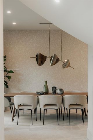a kitchen view with table and chairs