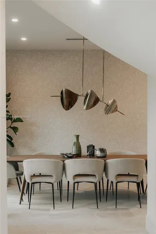 a kitchen view with table and chairs