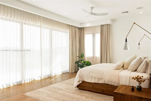 a white bath tub sitting next to a white sink and a mirror