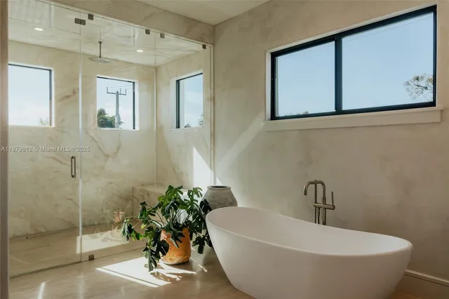 a bathroom with a double vanity sink mirror and bathtub
