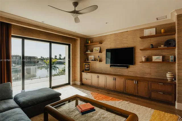 a living room with furniture pool table and a flat screen tv