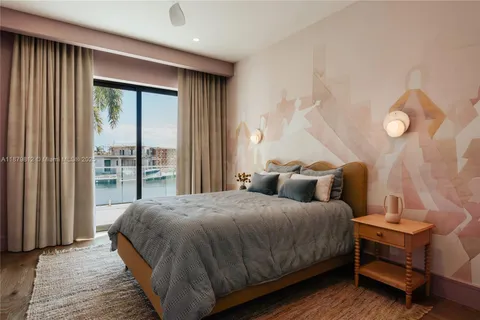 a living room with furniture a rug and wall paintings