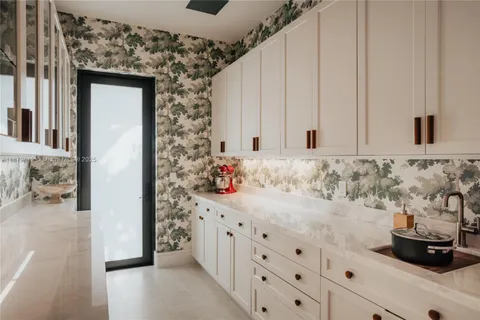 a view of a swimming pool with a patio and plants