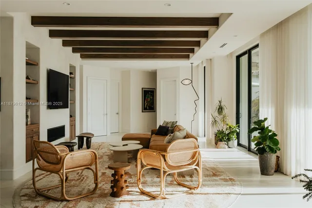 a very nice looking living room with furniture and a potted plant
