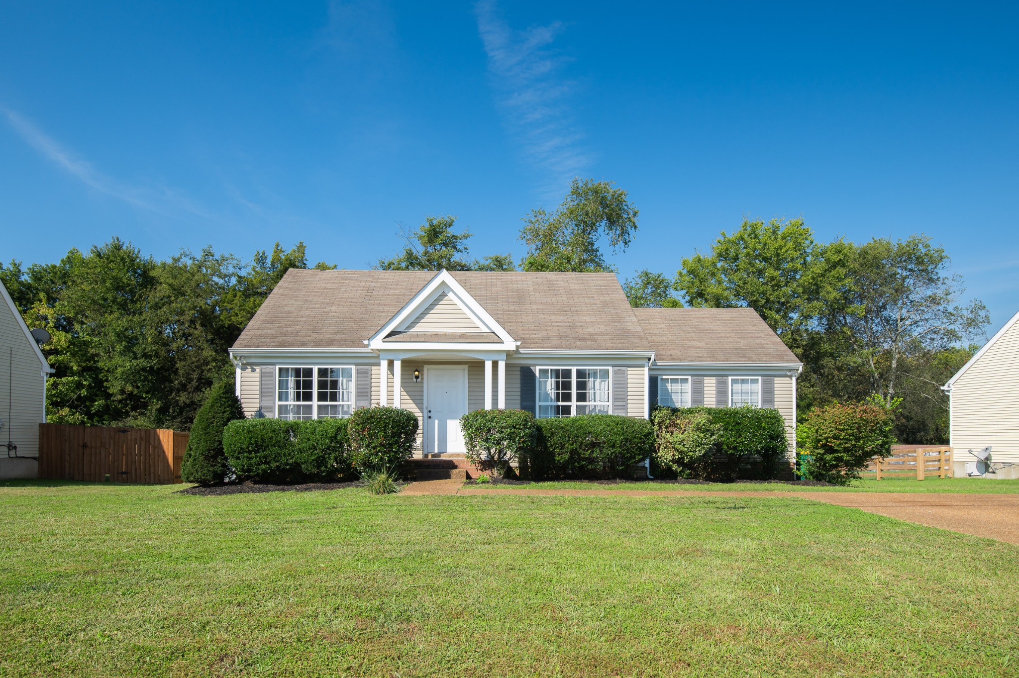 a front view of a house with a garden
