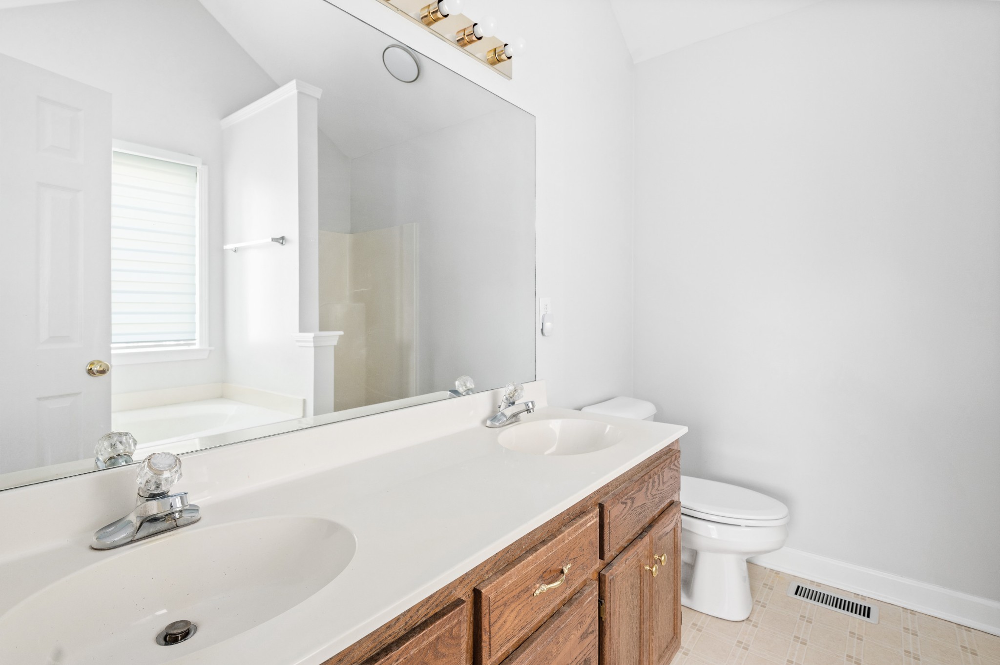 2849 Cochran Trace Drive Spring Hill, TN 37174 - Photo 19 of 27 a bathroom with a sink a toilet and a large mirror