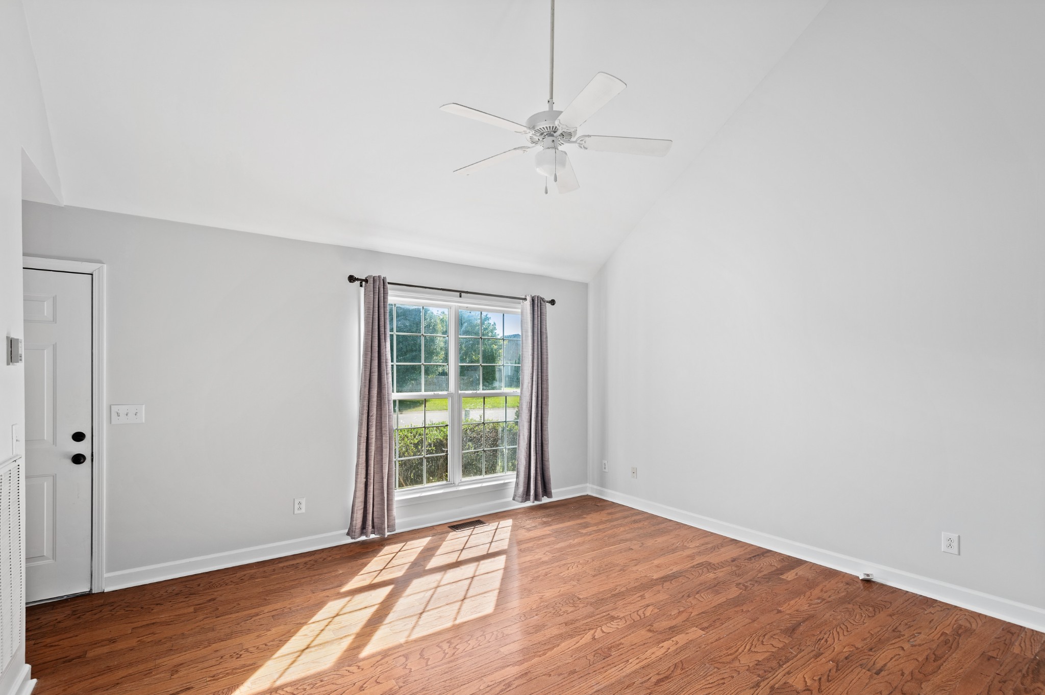 2849 Cochran Trace Drive Spring Hill, TN 37174 - Photo 5 of 27 a view of an empty room with wooden floor and a window