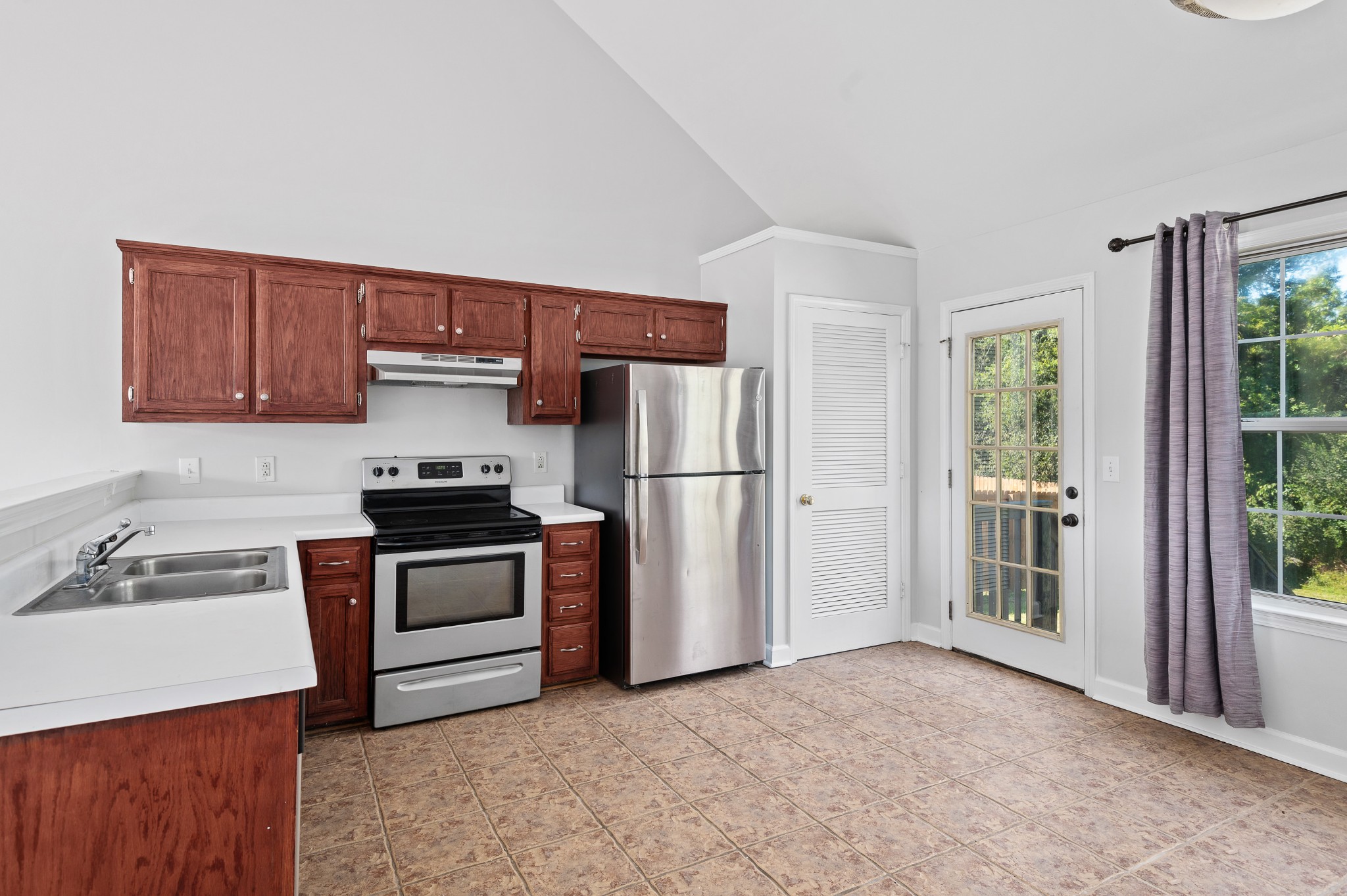 2849 Cochran Trace Drive Spring Hill, TN 37174 - Photo 8 of 27 a kitchen with stainless steel appliances granite countertop a refrigerator stove and sink